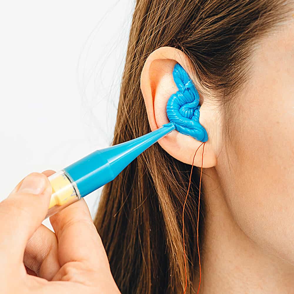 woman getting custom ear plugs